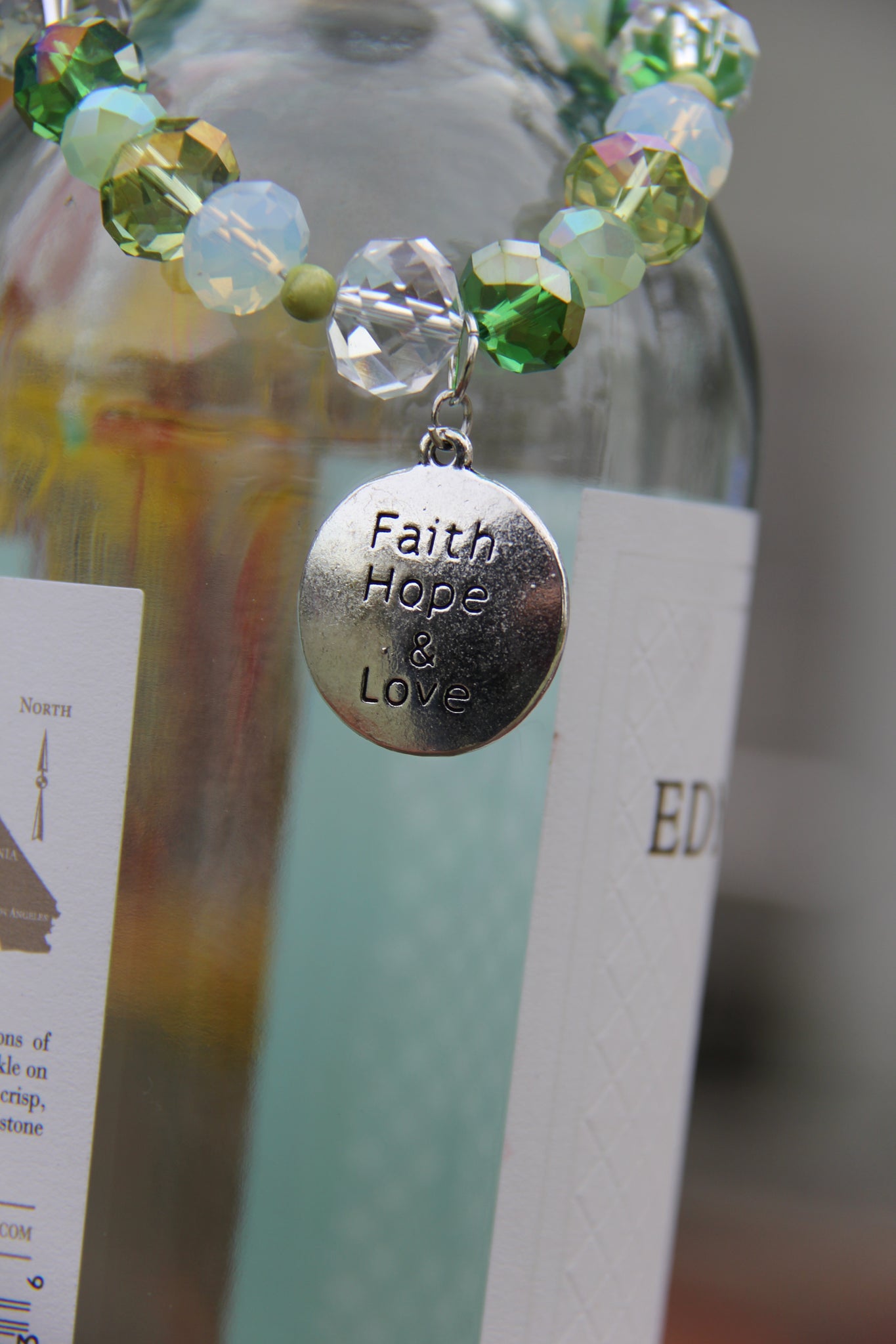 Faith, Hope & Love silver charm on a green glass beads bracelet