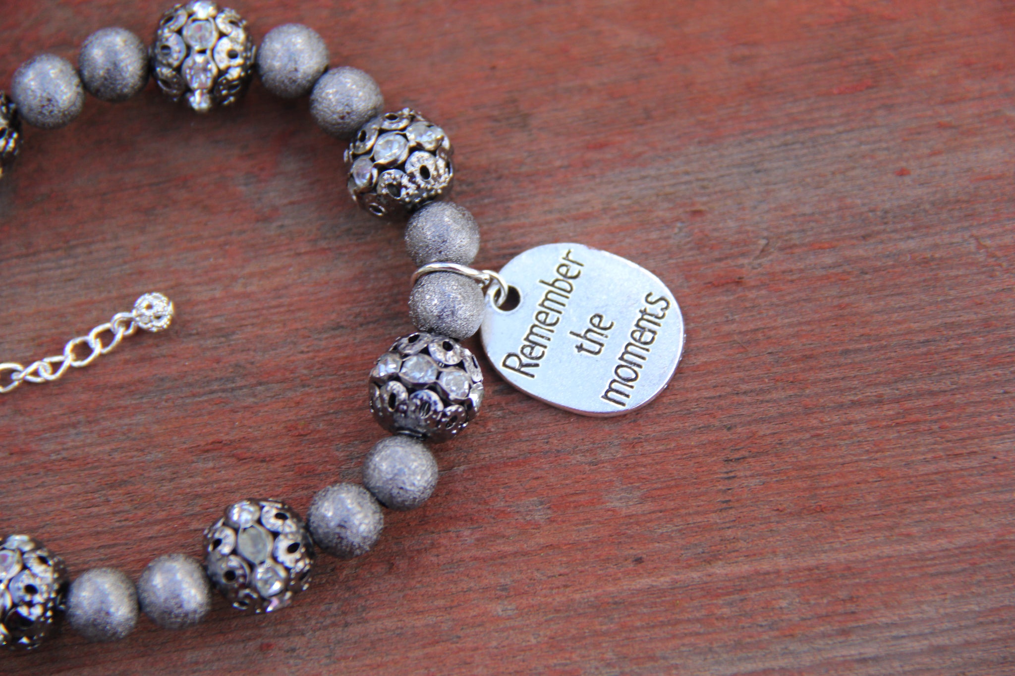 Grey colored lite weight beads with "Remember the moments" silver charm