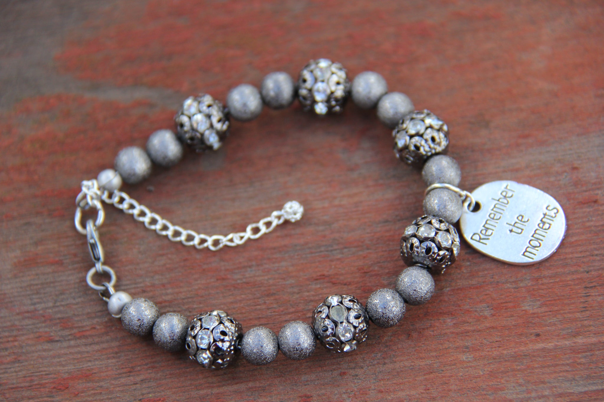 Grey colored lite weight beads with "Remember the moments" silver charm
