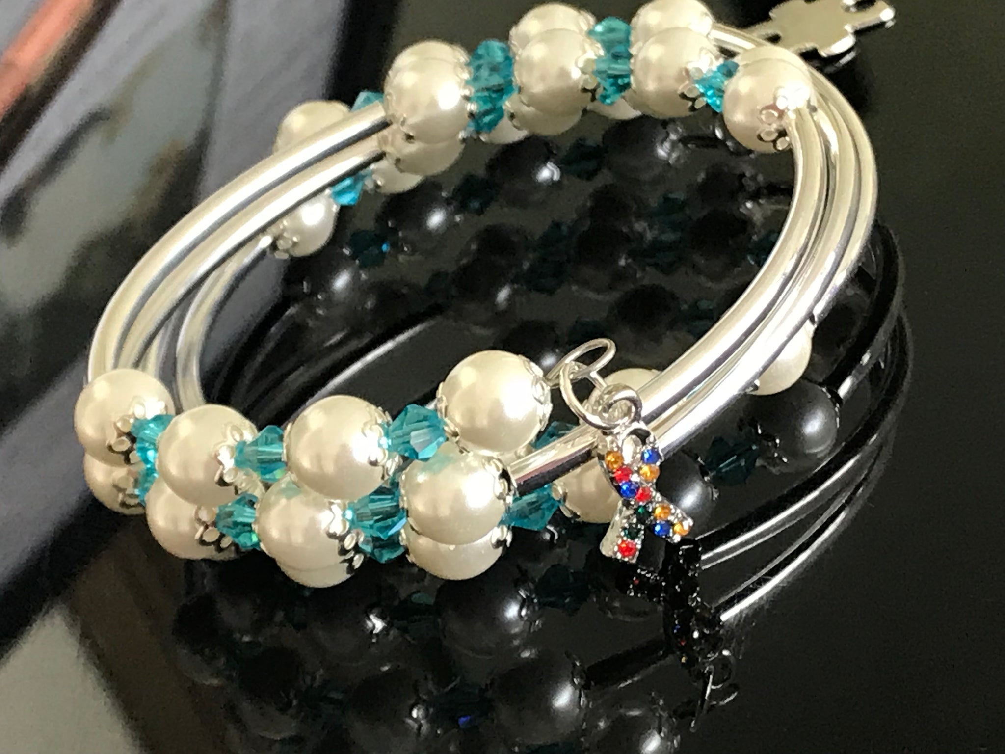 Autism awareness white glass pearls, Swarovski with silver noodle beads on a memory wire bracelet